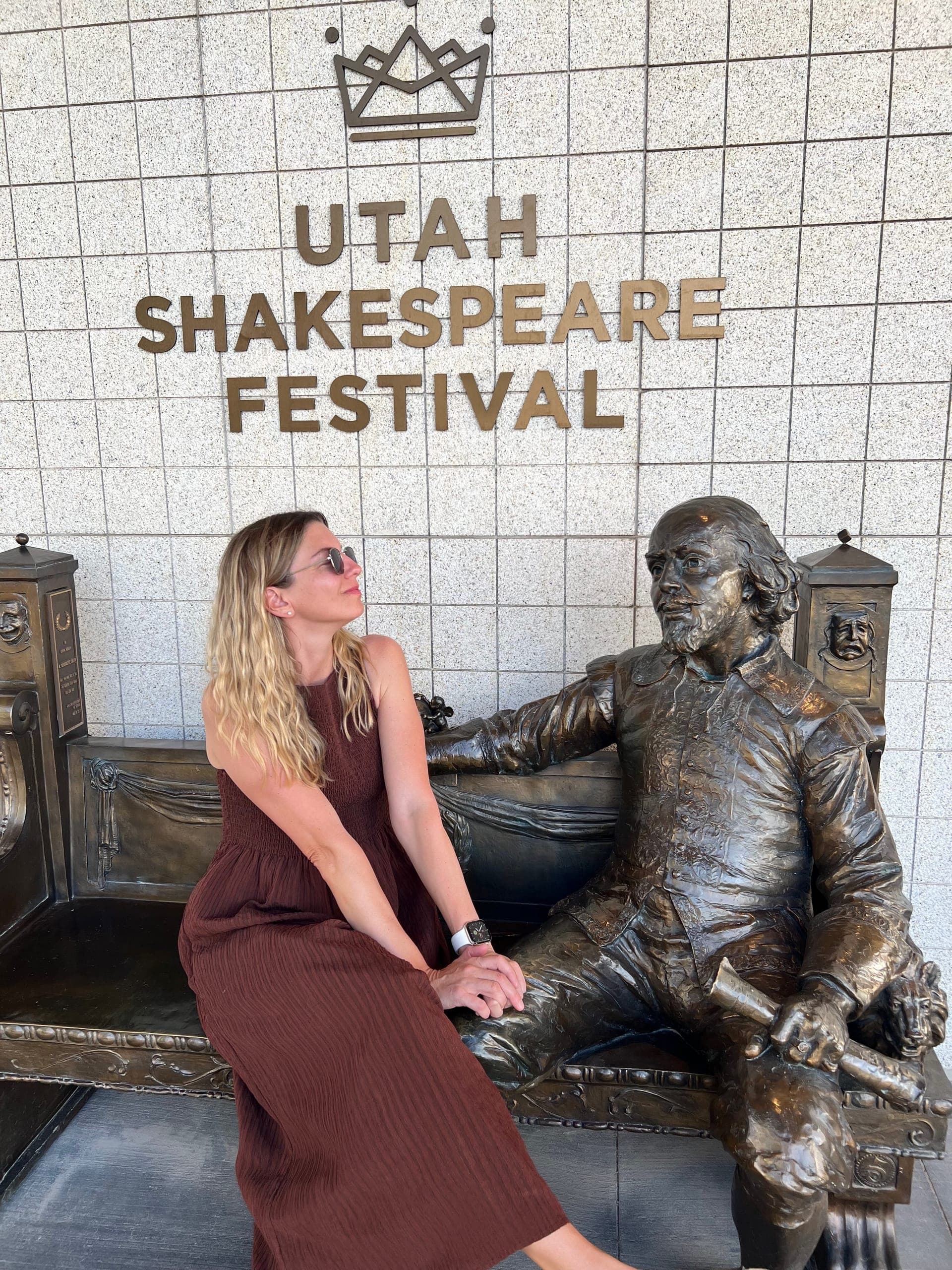 Sarah sharing a bench with a Shakespeare statue.