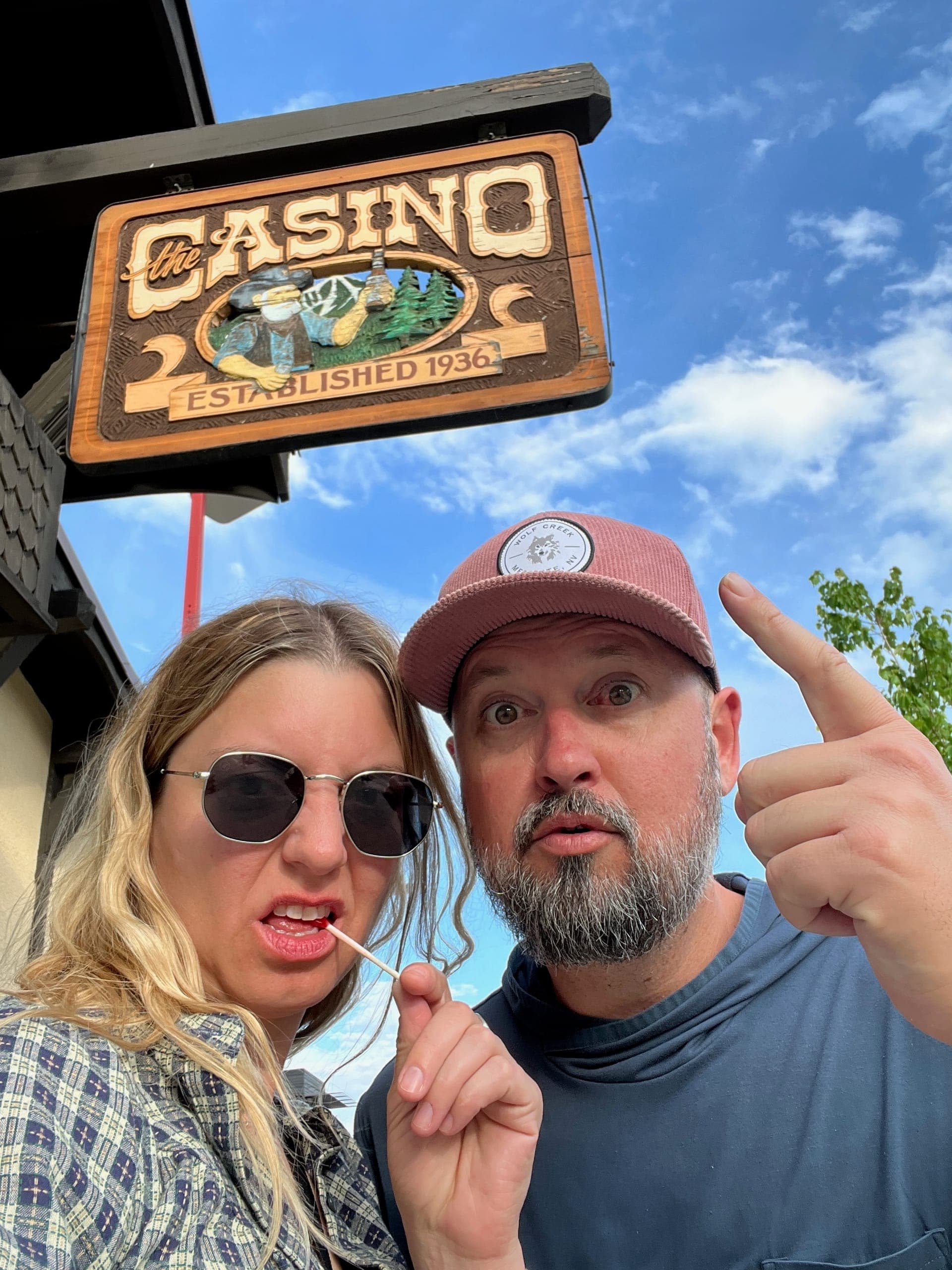 Selfie of Sarah and Erik in front of a sign that says Casino.