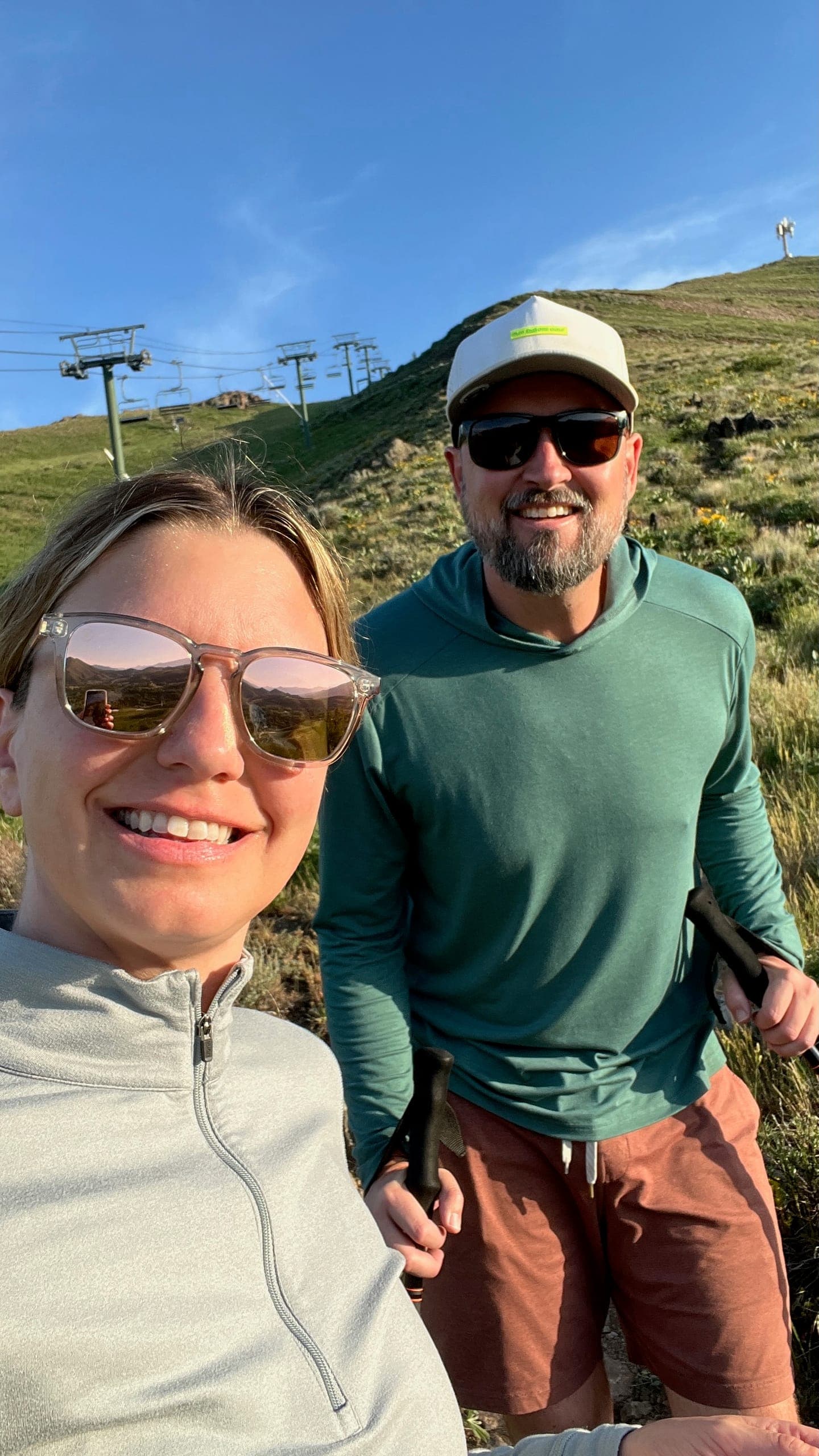 Selfie of Erik and Sarah out and about on Dollar Mountain with the chairlift towers climbing the ridge behind us.
