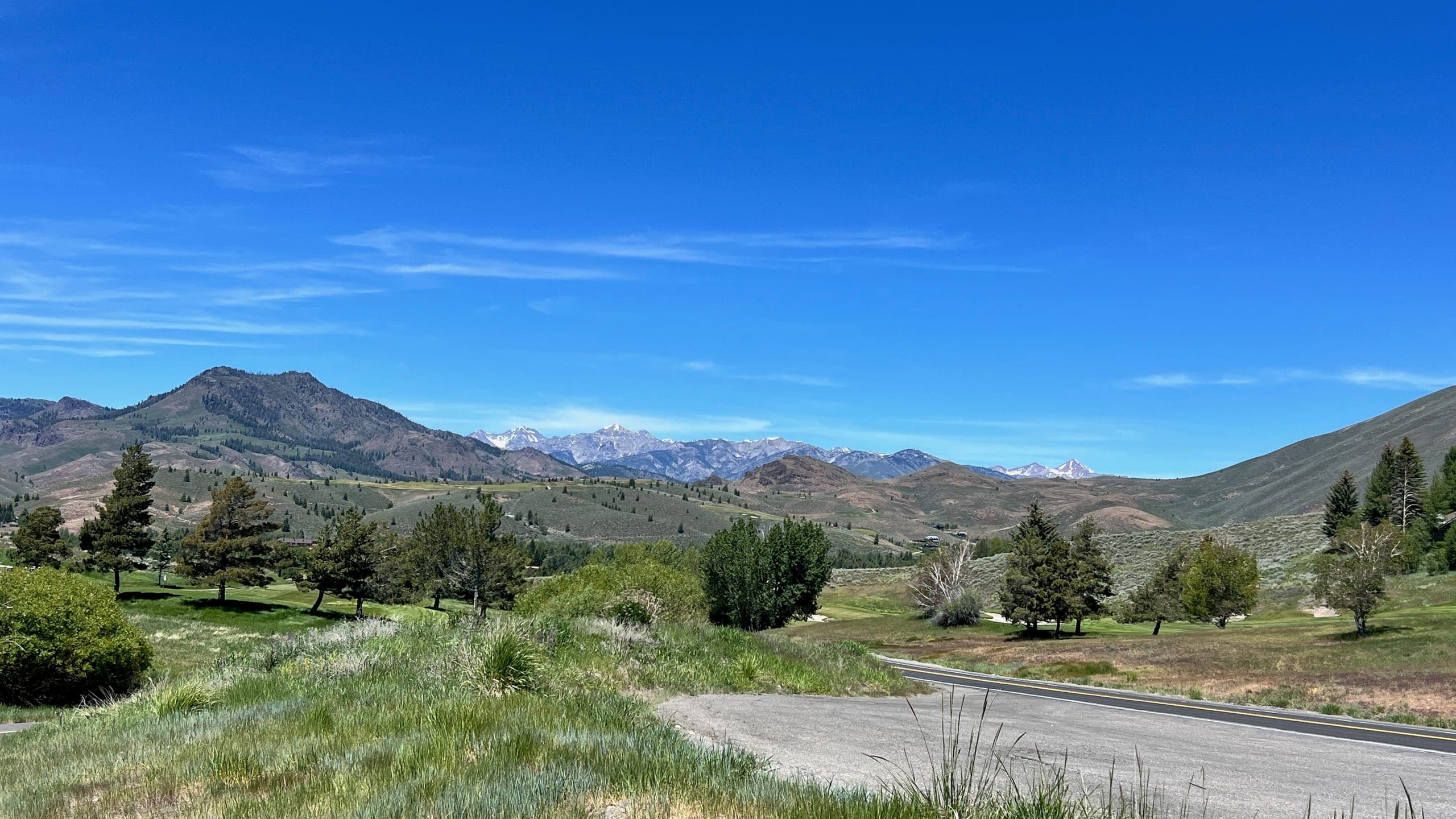 View of the Elkhorn golf course with Sun Valley hills and Sawtooth mountains in the background.