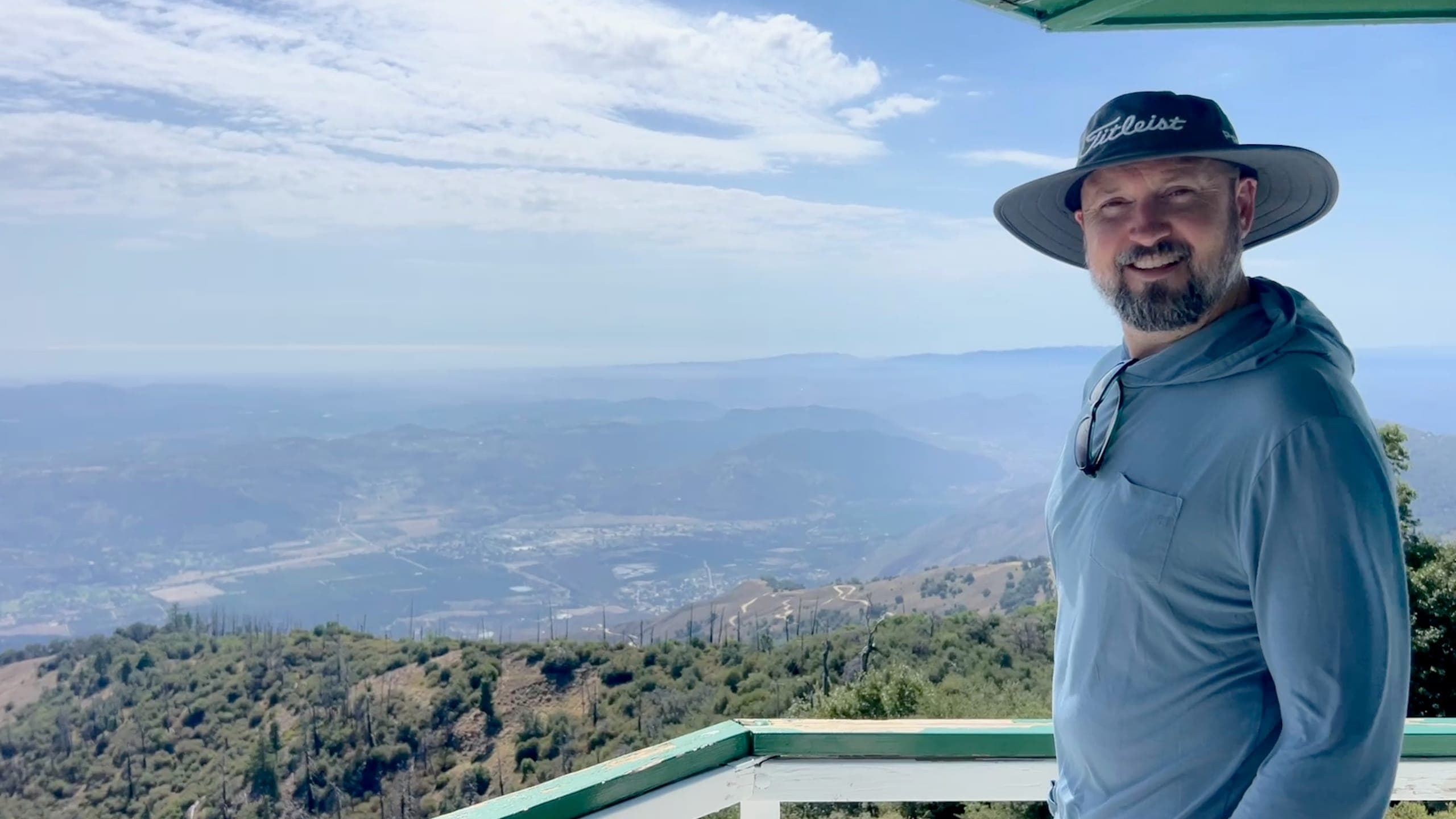 Erik on the catwalk of the Boucher lookout tower with the valley in the background.
