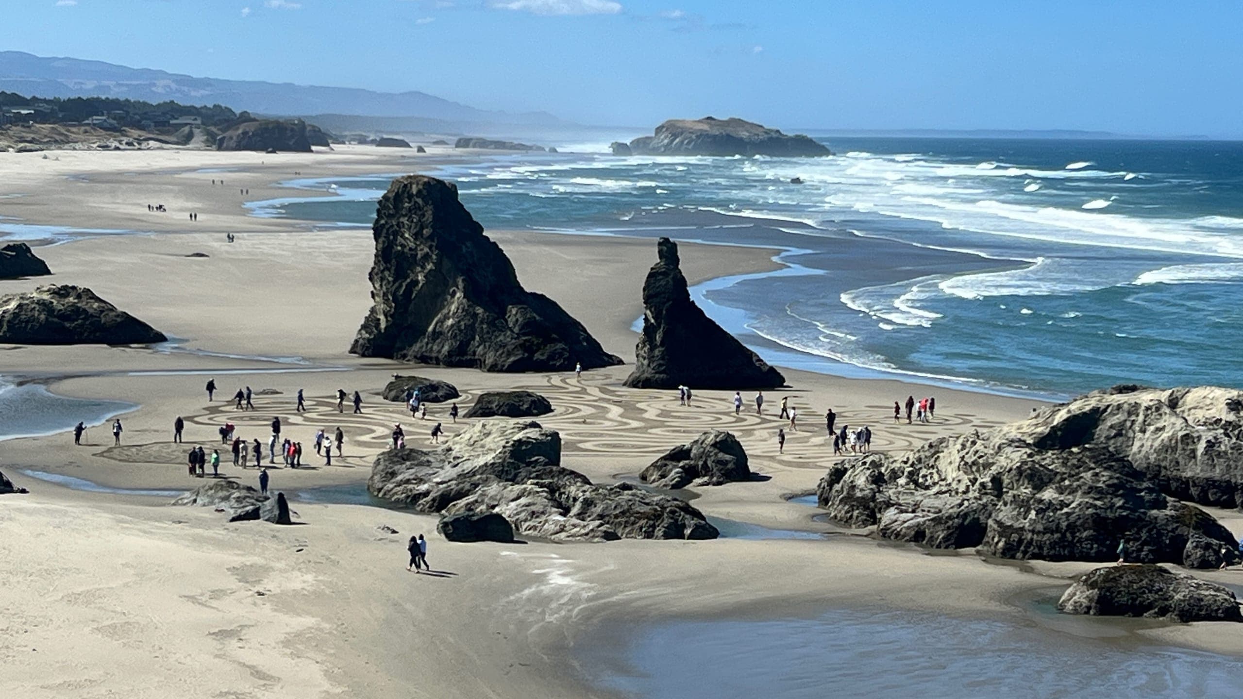 People walking the huge sand labyrinth created by Circles in the Sand.