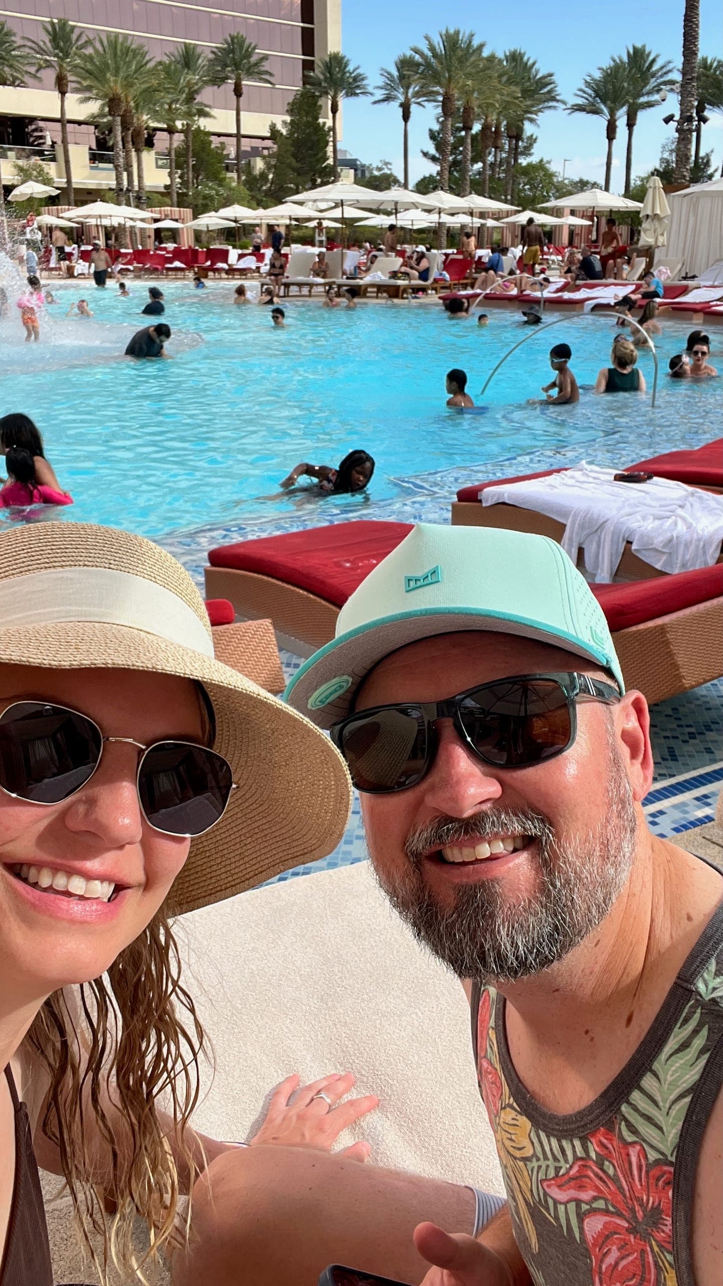 Selfie of Erik and Sarah sitting poolside.