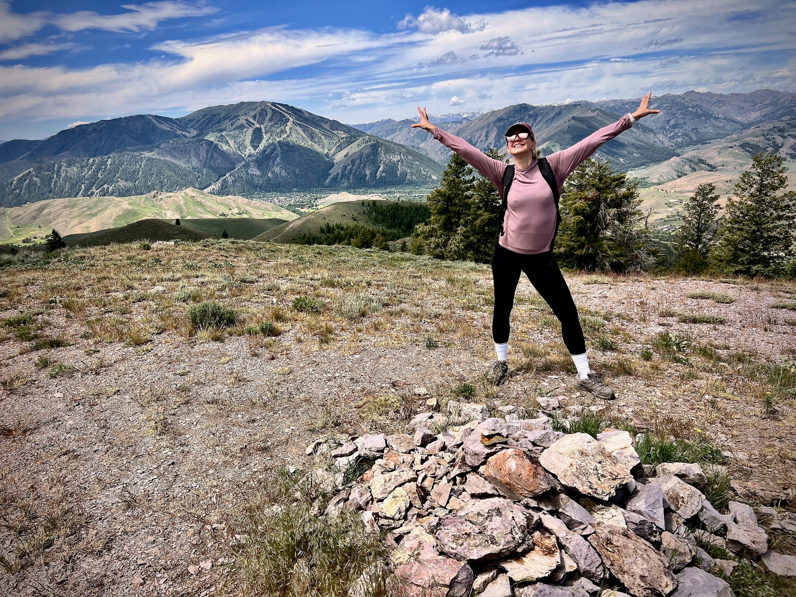 Sarah on Proctor Mountain next to a rock pile marking the summit.